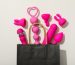 Sex toys spill out of a paper bag, top view